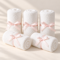 Rosy Lana set of five white bamboo face towels with pale pink ribbons on a light background