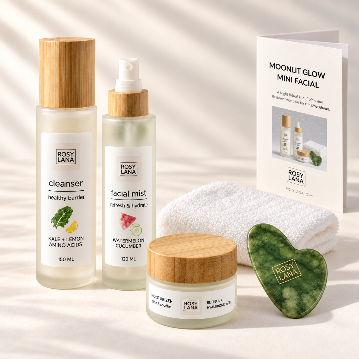 Rosy Lana Moonlit Glow Mini Facial with skincare, a folded white face towel, green jade gua sha and ritual guide on a light background